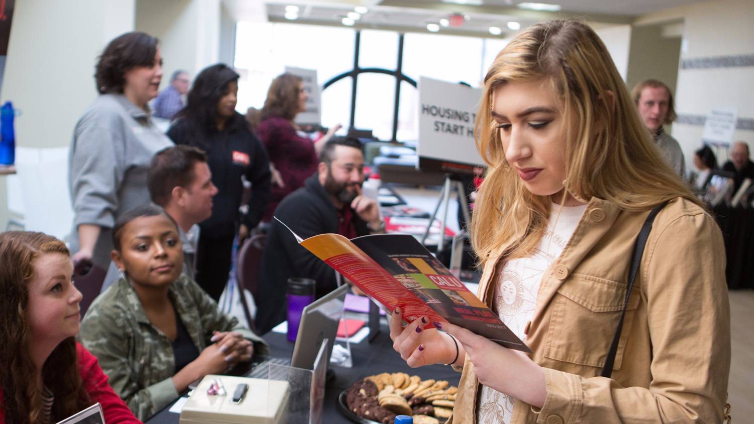 A PennWest California alumnus receives information about services.