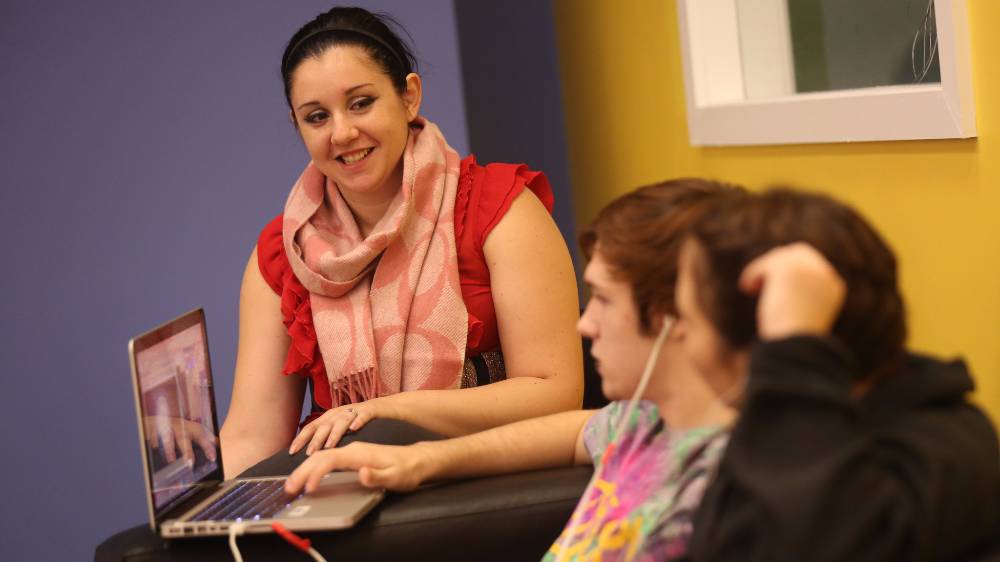 High school students work on their laptop.