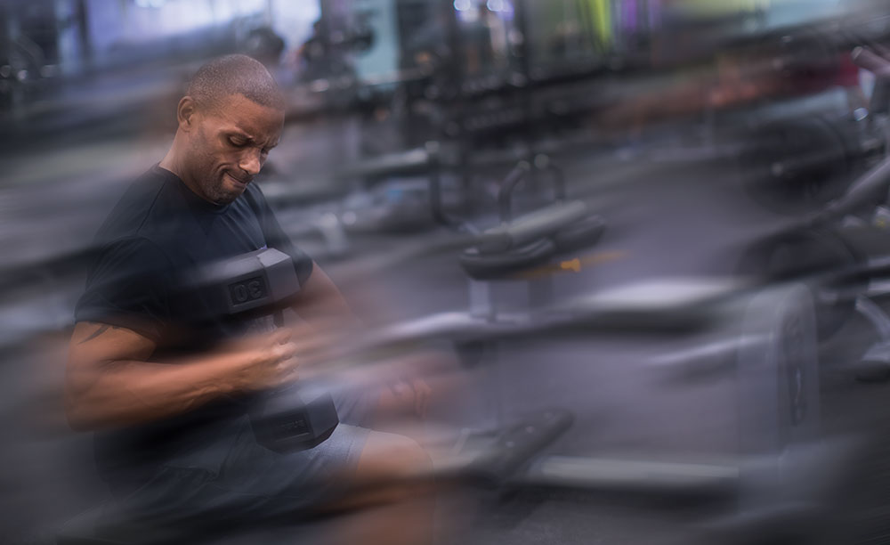 Aaron Jones lifting a dumbbell with his right arm.